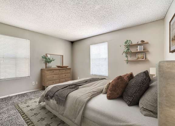 Spacious bedroom with wooden dresser and floating shelves at Peaks at Universal City Apartments, Universal City, TX