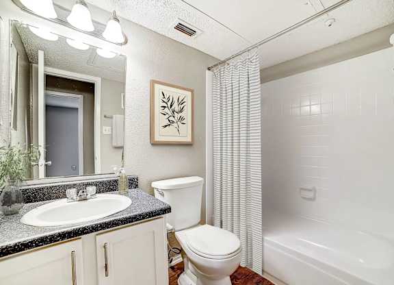 Bathroom with granite vanity and shower tub combo at Peaks at Universal City Apartments, Universal City, 78148