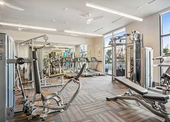 A gym with a variety of equipment including a leg press machine.