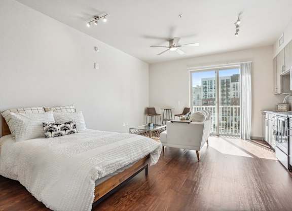 A bedroom with a large bed and a ceiling fan.