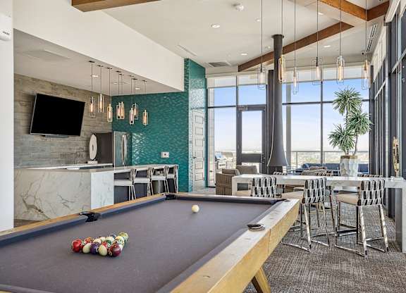 A pool table with balls set up in the middle of it.