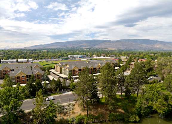 A view of a residential area with houses and trees.