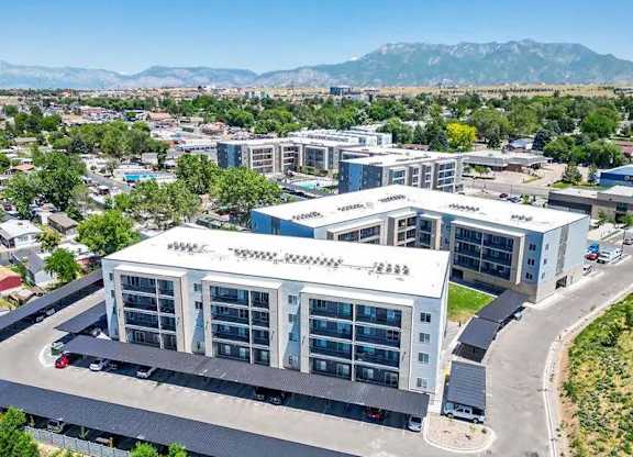 A large white building with a parking lot in front of it.