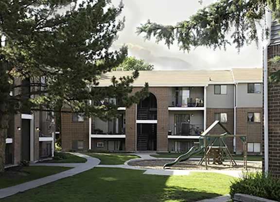 A playground area is located in front of a building.