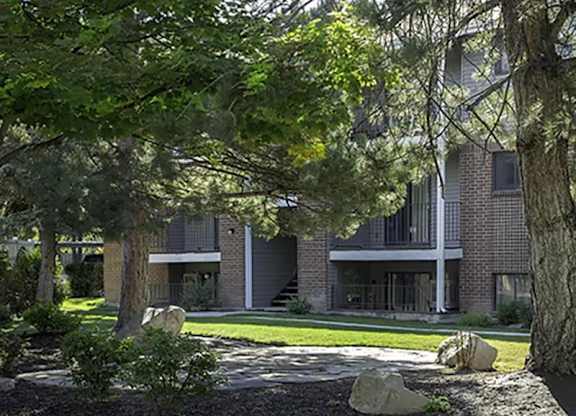 A modern building with a large tree in front.