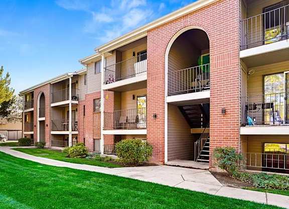 Apartment building with red brick and white trim.