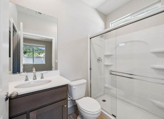 A White Bathroom with a Shower at Montessa Apartments, California, 95687