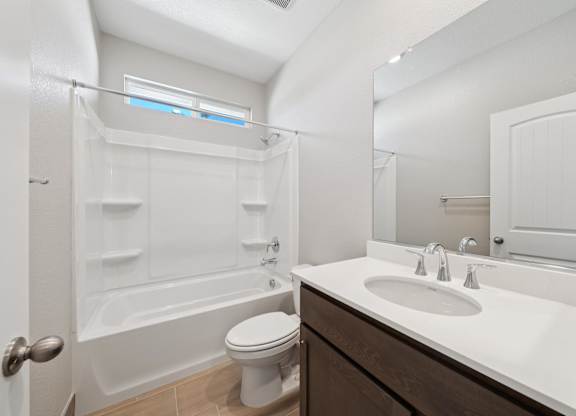 A White Bathroom with a Toilet at Montessa Apartments, Vacaville, CA, 95687
