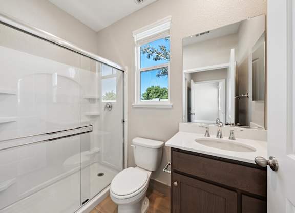 A Bathroom with a Mirror at Montessa Apartments, Vacaville