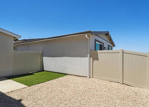 Backyard with Gravel Driveway at Montessa Apartments, California, 95687
