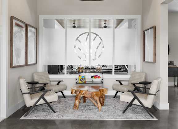 A modern living room with a large chandelier and a fireplace.