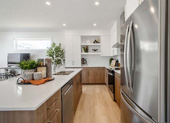 A modern kitchen with a large stainless steel refrigerator.