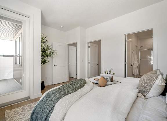 A bedroom with a large bed and a window.
