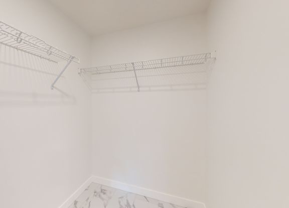 A white room with a metal rack on the wall.