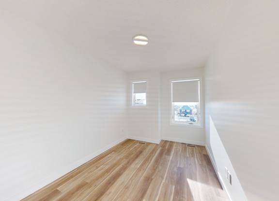 A room with wooden floors and white walls.