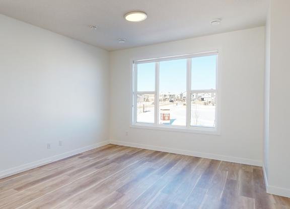 A room with a window overlooking a cityscape.