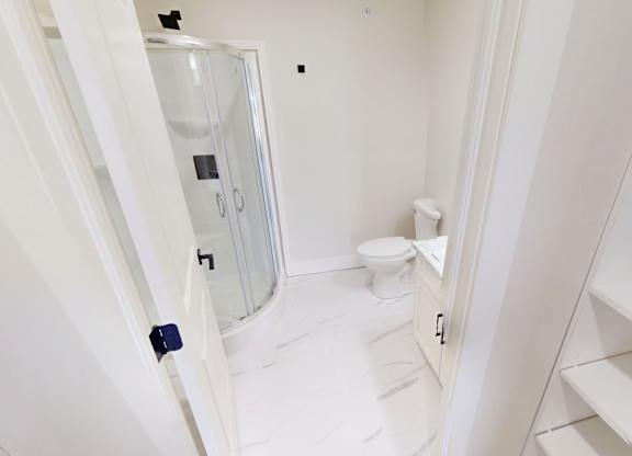 A white bathroom with a toilet and sink.