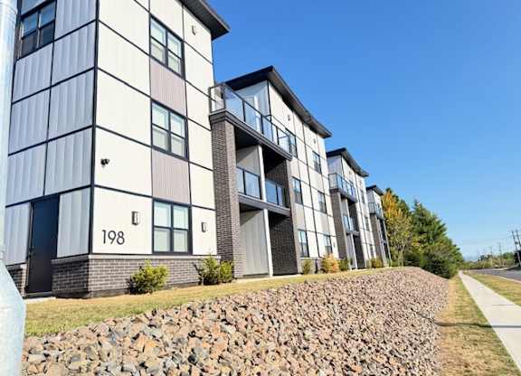 A modern apartment building with the number 198 on the front.