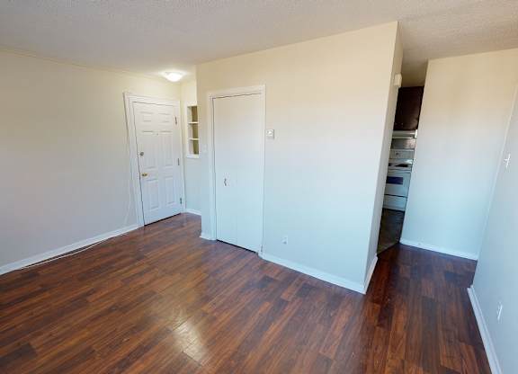 A room with wooden floors and white walls.