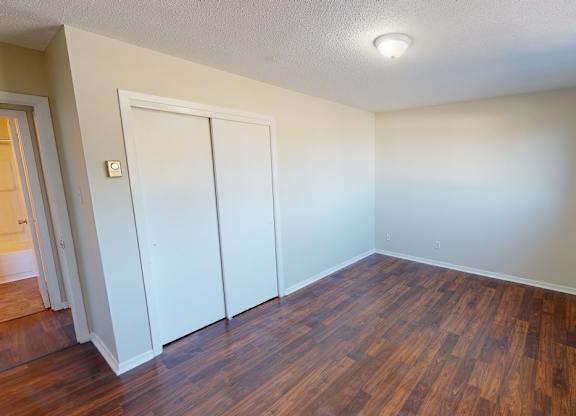 A room with a wooden floor and white walls.