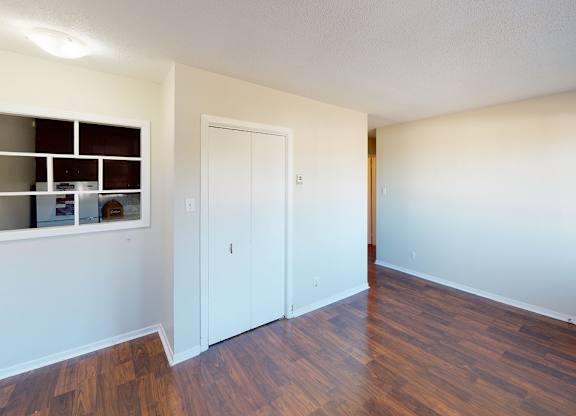 A room with a white door and a window with a white frame.