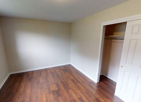 A room with wooden floors and a white door.