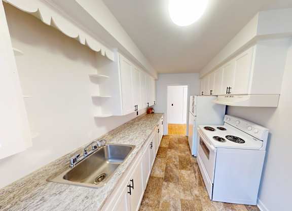 A kitchen with a stove and a sink.