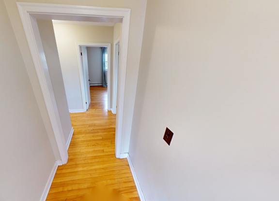 A long hallway with a door at the end.