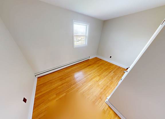 A room with wooden floors and white walls.
