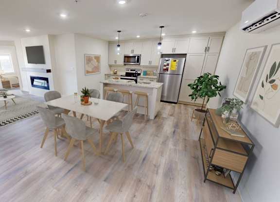 A modern open plan living and kitchen area with a dining table and chairs.