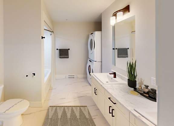 A white bathroom with a toilet, sink, and mirror.