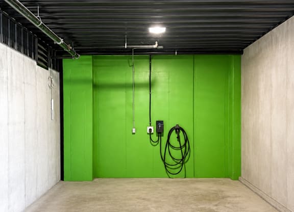 A parking space with a green sign on the floor.
