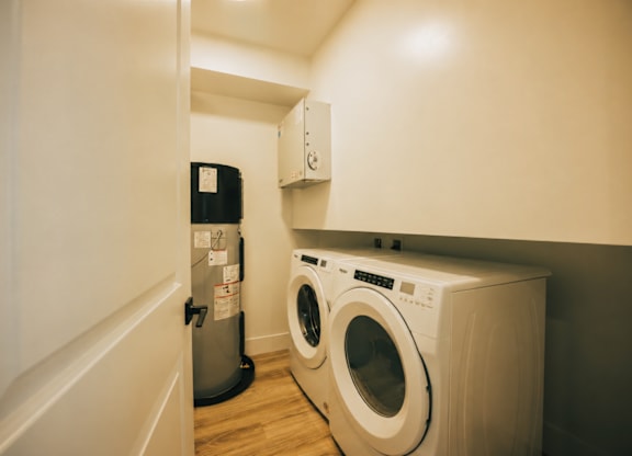 A white washing machine in a small laundry room.