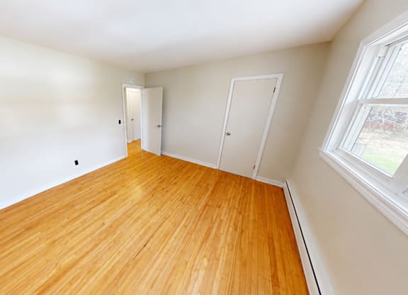 A room with wooden floors and white walls.