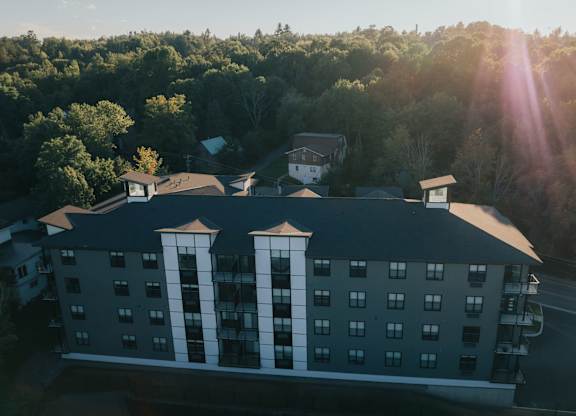 A hotel building with a sun flare in the background.
