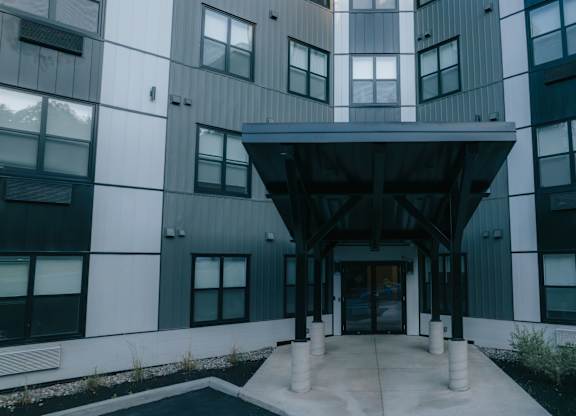 A modern building with a central entrance and a black and white color scheme.