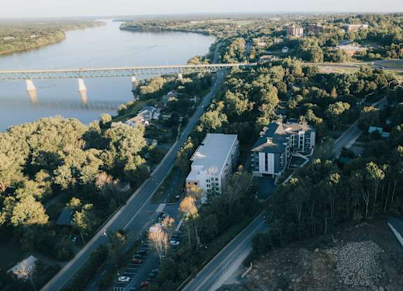 A river flows through a city with a bridge crossing over it.