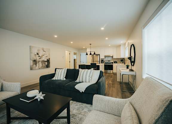 A black and white living room with a couch, armchair, and coffee table.