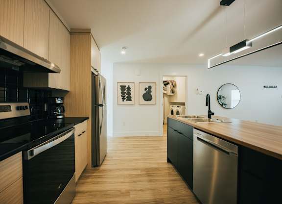 A modern kitchen with wooden cabinets and stainless steel appliances.