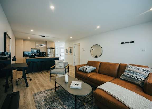 A living room with a brown couch and a coffee table.