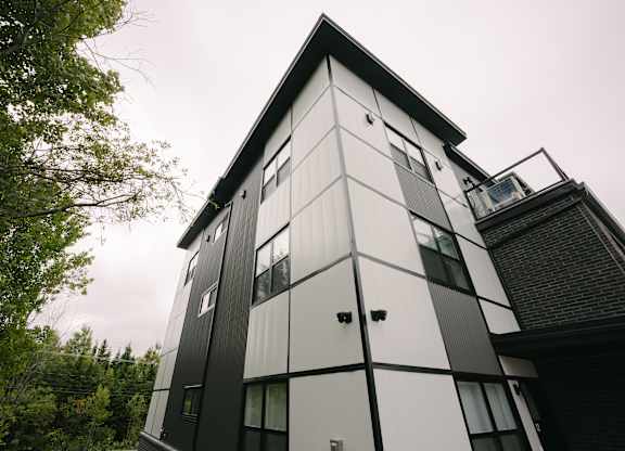 A modern black and white building with a triangular roof.