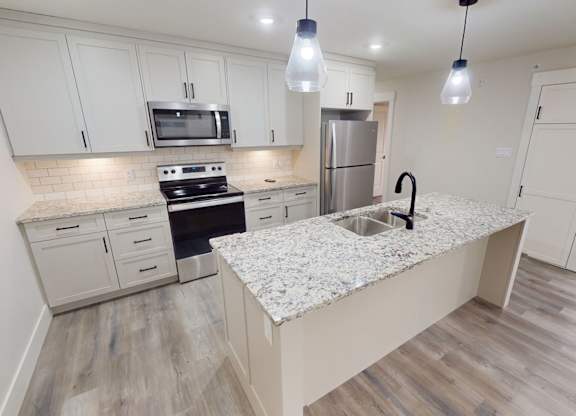 A kitchen with a granite countertop and a sink.