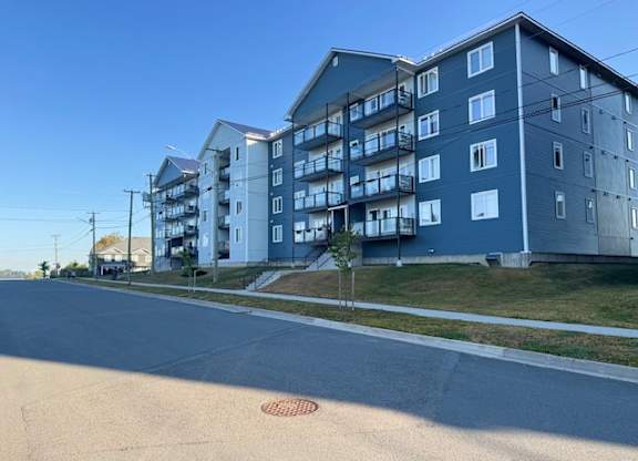 A street view of a residential area with apartment buildings.