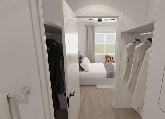 A white room with a bed and a wardrobe.