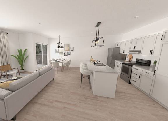 A modern kitchen and living room with a grey sofa and wooden chairs.