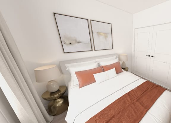 A bedroom with a white bed and a brown blanket.