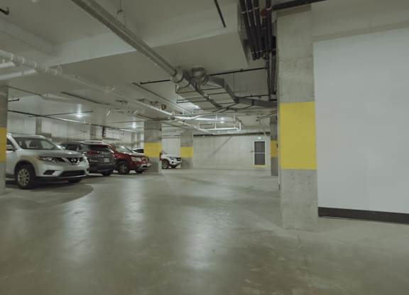 A parking garage with cars parked in it.