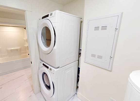 A white washing machine and dryer in a small laundry room.