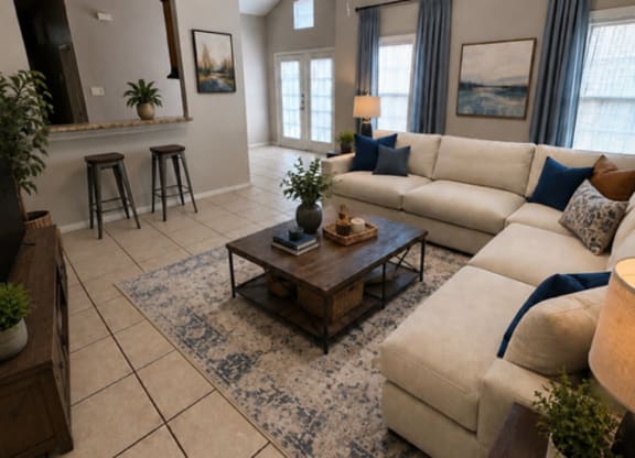 A living room with a white couch and a coffee table.