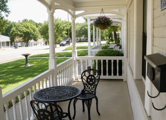 A patio with a table and chairs.